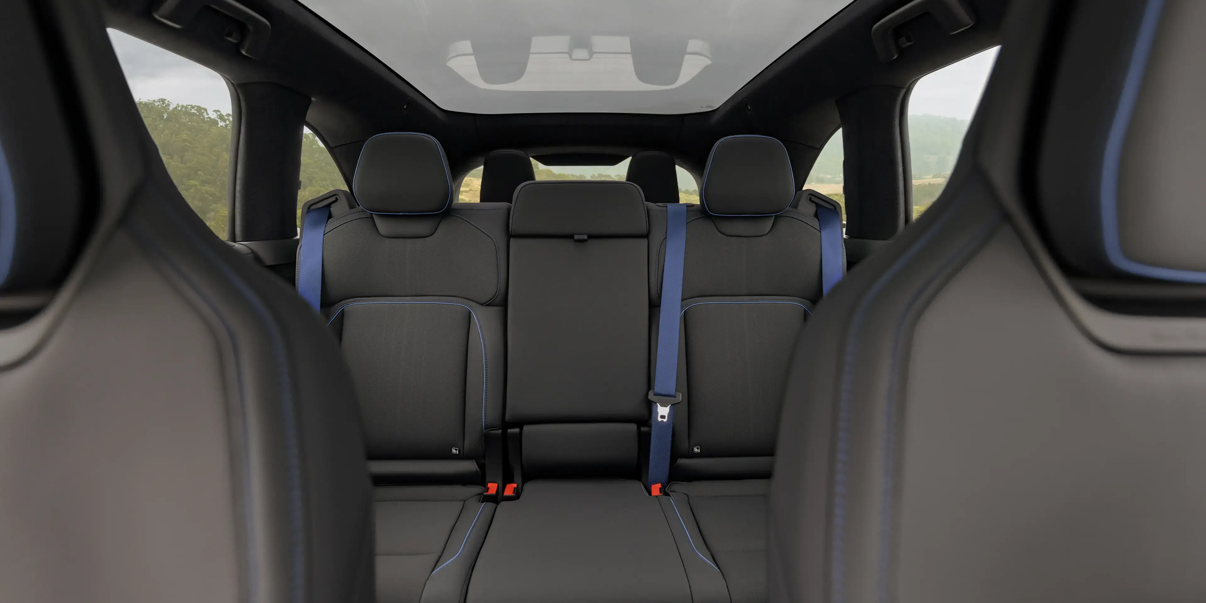 Rear cabin of the Lucid Gravity GT-S with blue seatbelts and blue stitching
