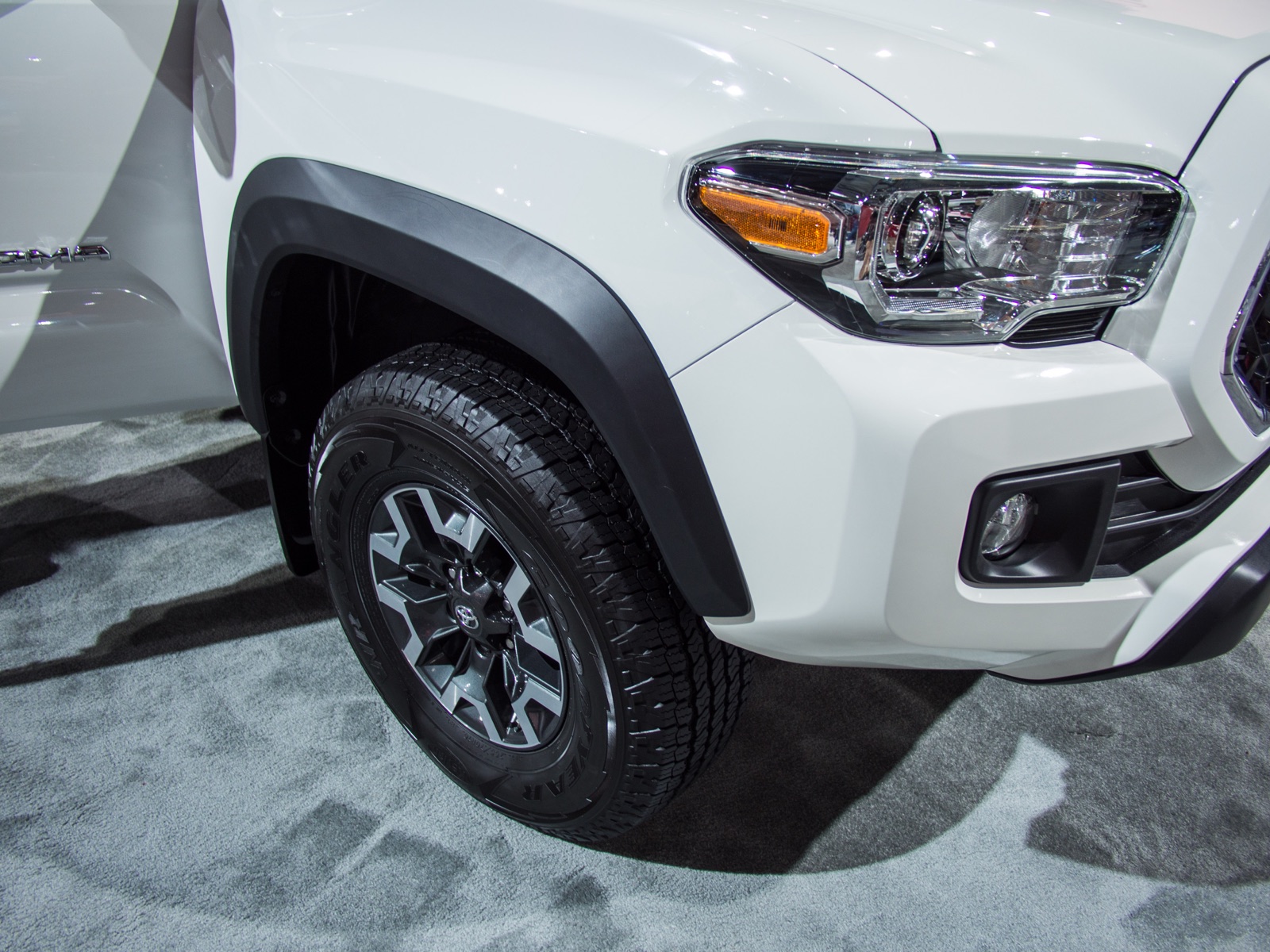 Front quarter of a white 2018 Toyota Tacoma pickup truck